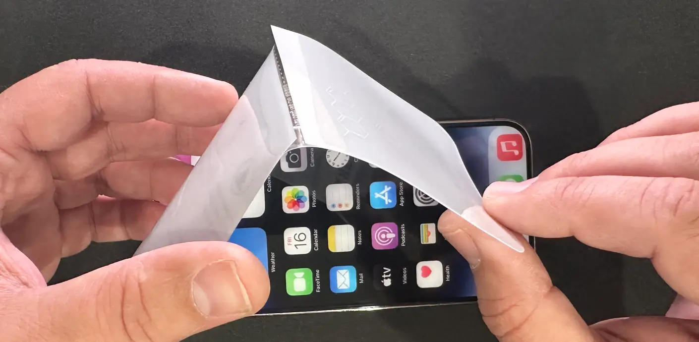 The lower two-part protective layer (this side goes onto the display)
